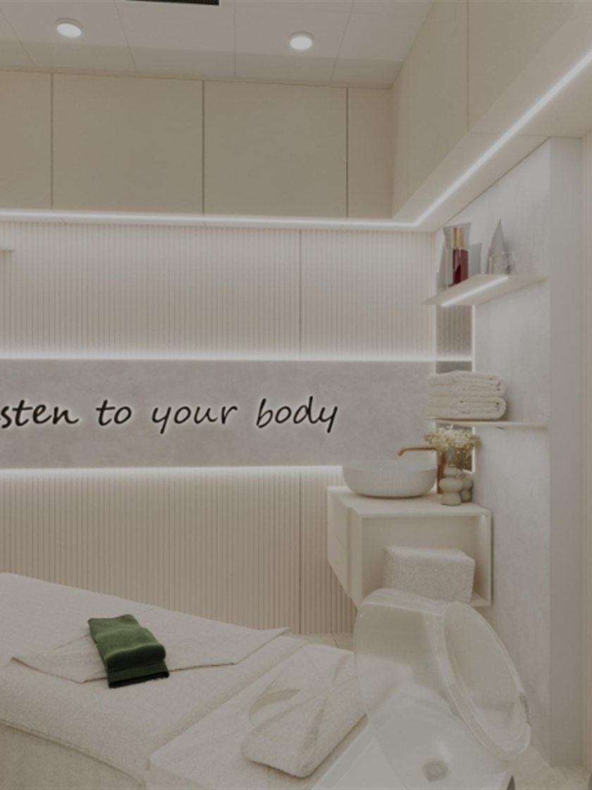 Calm spa treatment room with soft cove lighting and bespoke fluted wall panelling